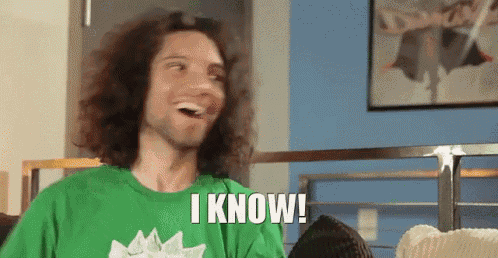 a man with long curly hair is wearing a green shirt that says i know .