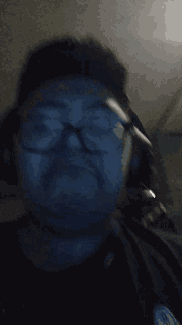 a man wearing glasses and headphones is looking at the camera