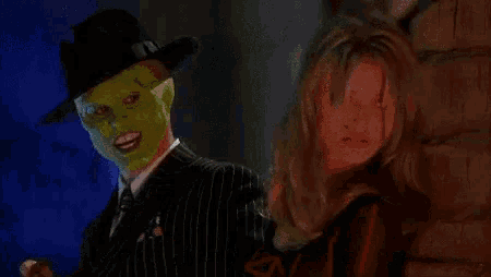 a man in a mask is smoking a cigar next to a woman ..