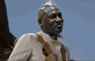 a man wearing suspenders and a white shirt is looking at something