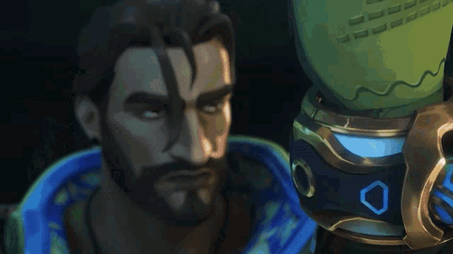 a man with a beard is standing next to a green object with a blue o on it