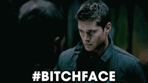 a man in a black jacket is looking at another man with the words #bitchface above him