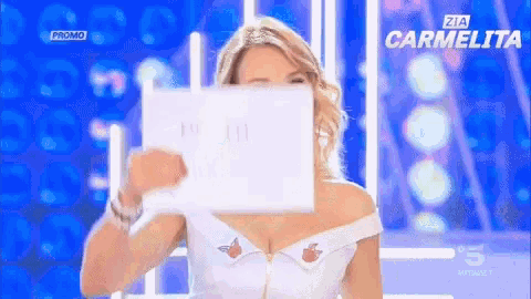 a woman is holding a piece of paper in front of her face and the word promo is on the bottom