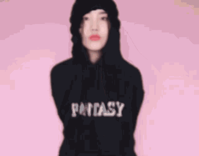 a woman wearing a black hoodie with red lips