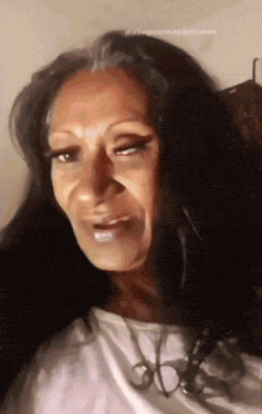 a close up of a woman 's face with the words distinctiveheadgentleman written below her