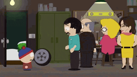 a group of cartoon characters are standing around a tire in a garage