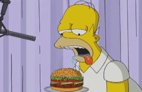 homer simpson from the simpsons eating a hamburger
