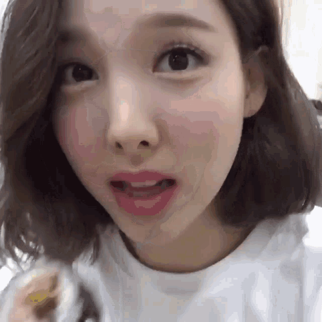 a close up of a girl 's face with her mouth open
