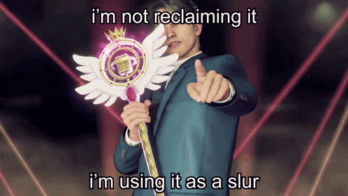 a man in a suit is holding a wand with wings and a crown on it