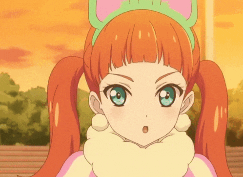 a girl with orange hair and blue eyes is wearing a headband with cat ears