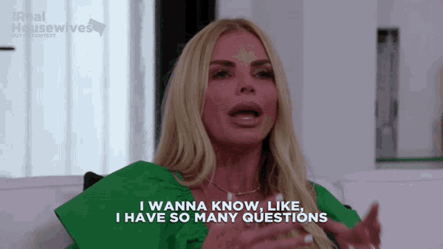 a woman is sitting on a couch and says " i wanna know like i have so many questions "