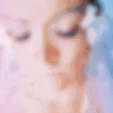 a woman wearing ear buds looks at the camera