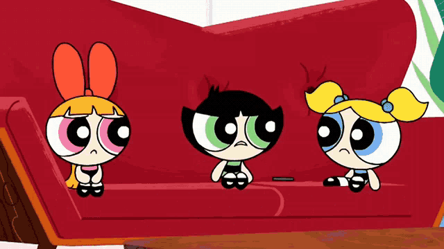 three cartoon characters are sitting on a red couch looking sad