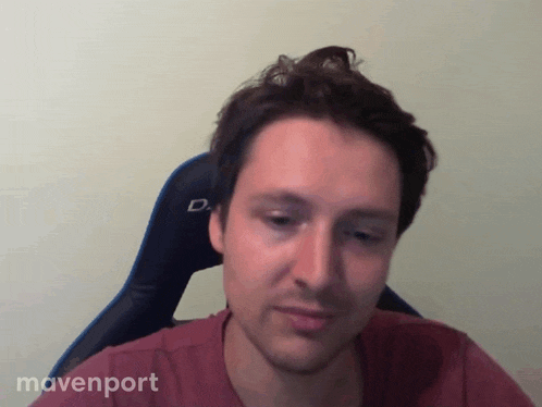 a man sitting in a chair with mavenport written on the bottom of his shirt