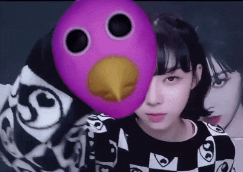 a girl is wearing a purple mask with a yellow beak on her face .