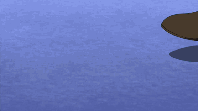 a soccer ball and a person 's foot are on a blue surface