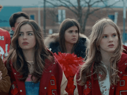 a group of girls wearing red jackets with the letters rs on them