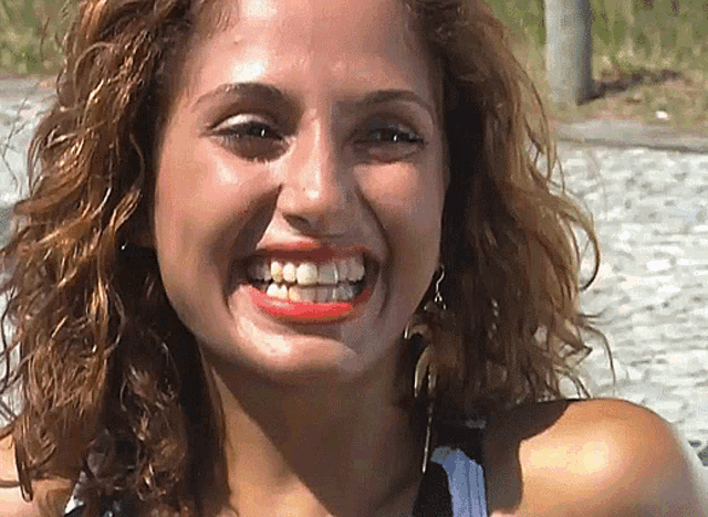 a close up of a woman 's face with her mouth open