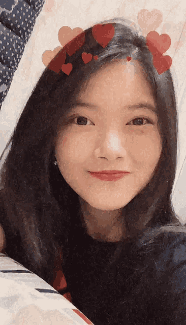 a young girl with hearts on her head looks at the camera