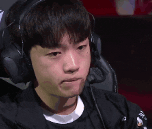 a young man is wearing headphones and smiling while playing a video game