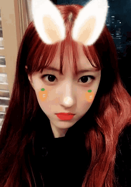 a girl with bunny ears on her head looks at the camera
