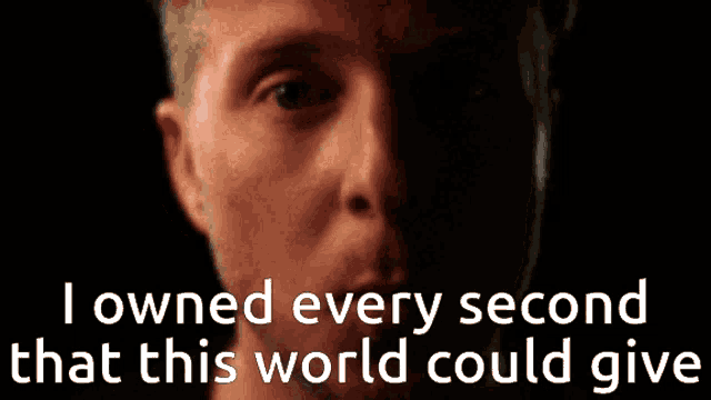 a close up of a man 's face with the words " i owned every second that this world could give " behind him