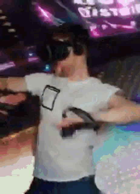 a man wearing a virtual reality headset is dancing
