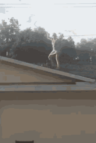 a person is standing on the roof of a house .