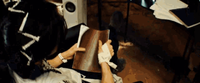 a person is reading a book with a bandaged hand