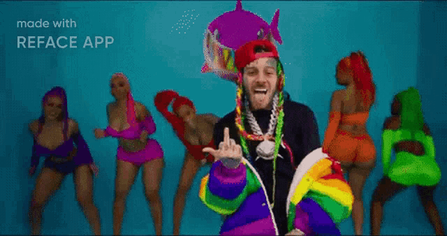a group of women are dancing in front of a man in a colorful outfit .