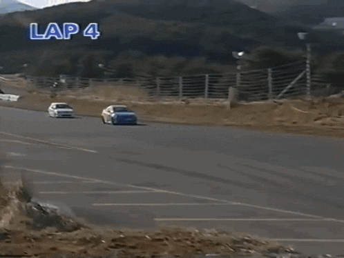 a yellow and blue race car is driving down a road .