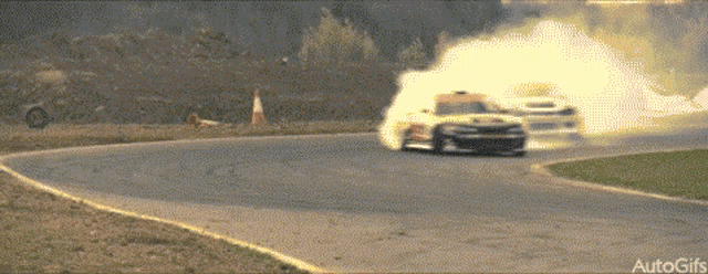 a car is going around a curve with smoke coming out of it and the words autogifs at the bottom