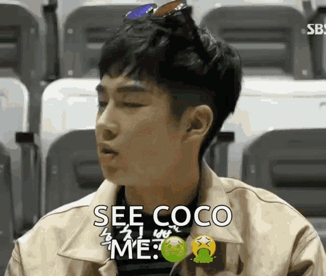 a man with sunglasses on his head is sitting in a stadium and saying see coco me