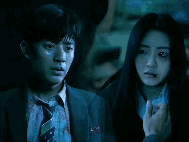 a man in a suit and tie is standing next to a woman with a black eye