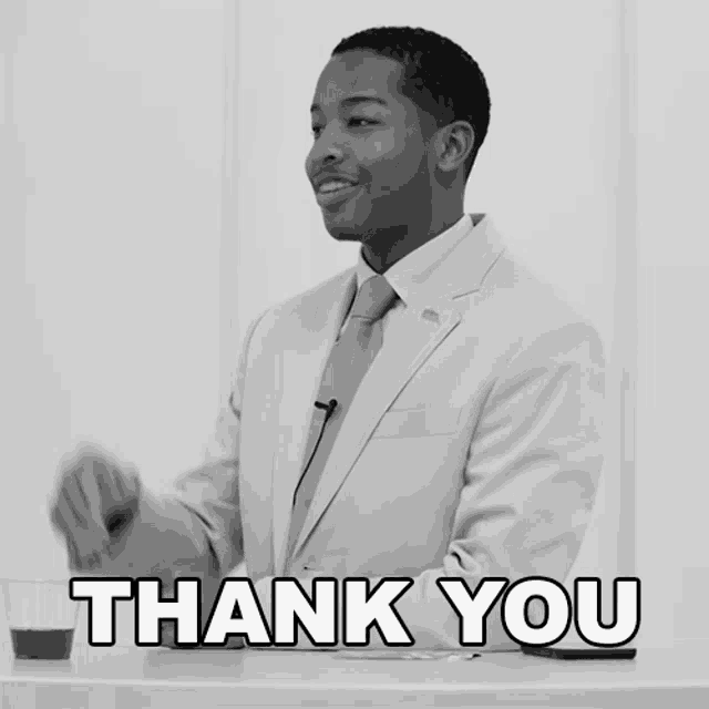 a black and white photo of a man in a suit and tie with the words thank you below him