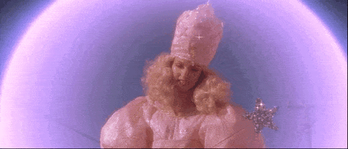 a woman in a pink dress and white hat is standing in front of a purple circle .