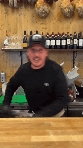 a man wearing a black shirt with a sticker on the front that says ' a '