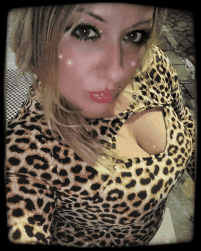 a woman wearing a leopard print top with a cut out in the chest