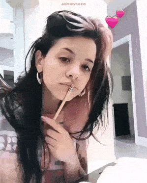a girl is holding a pencil in her mouth and the word adventure is on the bottom