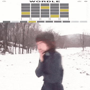 a woman standing in a snowy field next to a wordle display