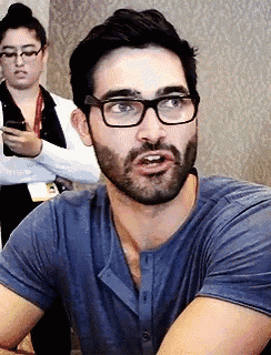 a man with glasses and a beard is looking at the camera