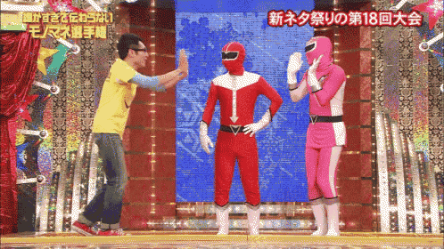 a man in a yellow shirt talks to a man in a red costume
