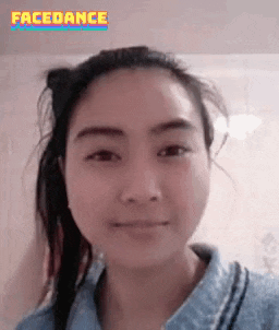 a woman in a blue shirt is making a funny face and the words facedance are above her .