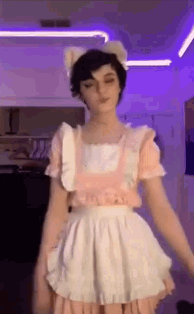 a person is wearing a maid costume and a cat ear headband .