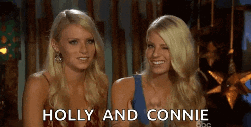 two blonde women are sitting next to each other and smiling with the words holly and connie above them .