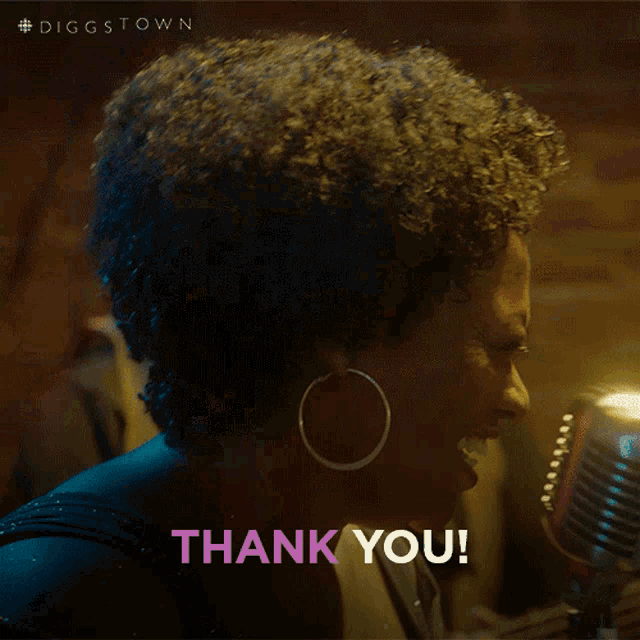 a woman singing in front of a microphone with the words thank you written below her