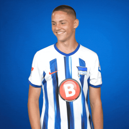 a man wearing a blue and white striped jersey with the letter b on the front