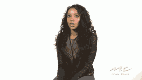 a woman in a leather jacket is holding a sign that says i never
