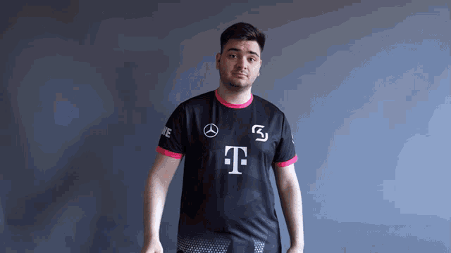 a man wearing a black and pink t-mobile jersey