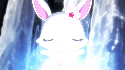 a white rabbit with a pink flower on its ear